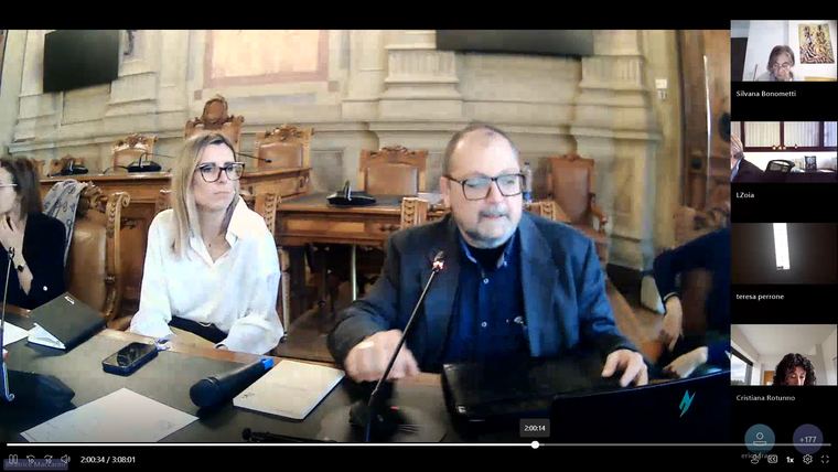 Speakers at the presidency table, seen from the online session